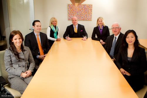 A corporate group, positioned around a conference table